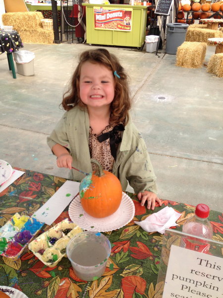 Painting a pumpkin for one of the many fall activities in the Grand Rapids area