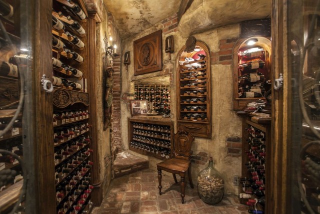 The temperature controlled 4,000 bottle wine room in this Corona Del Mar, CA property listed by Georgina Jacobson with Coldwell Banker Residential Brokerage brings new meaning to ambiance.