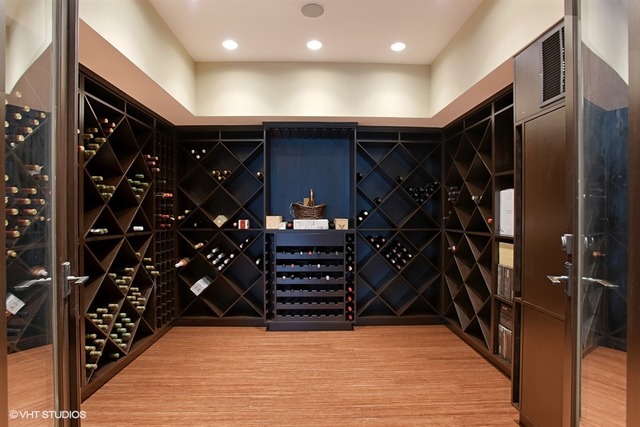 The modern wine room in this Chicago, IL home listed by Chezi Rafaeli dwarfs many walk-in-closets.