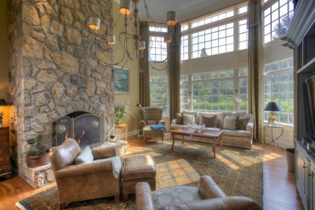 Warm up your toes by the fire and bask in the warm glow of the sunlight streaming in from the floor to ceiling windows of this Mendham, NJ great room.