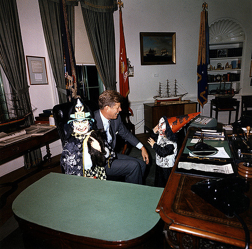 ST-C372-6-63 31 October 1963 Halloween visitors with the President. President Kennedy, John F. Kennedy Jr., Caroline Kennedy. White House, Oval Office. Photograph by Cecil Stoughton, White House, in the John F. Kennedy Presidential Library and Museum, Boston.
