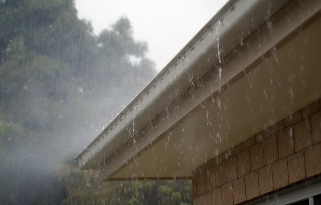 Rainwater spilling over gutters in a rainstorm