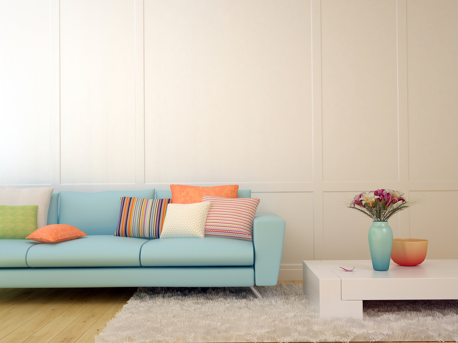 Bright composition of a light blue sofa with cushions and a white table on the white carpet