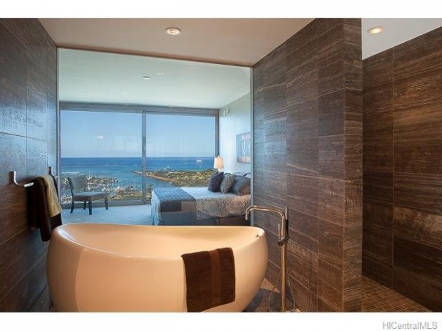 This Honolulu penthouse master bathroom features a free standing bathtub, as well as a glass wall which allows natural light to flow into the space. Located at 1555 Kapiolani Boulevard, Honolulu, HI this property is listed at $3.8 million by Iku S. Honda with Coldwell Banker Pacific Properties.
