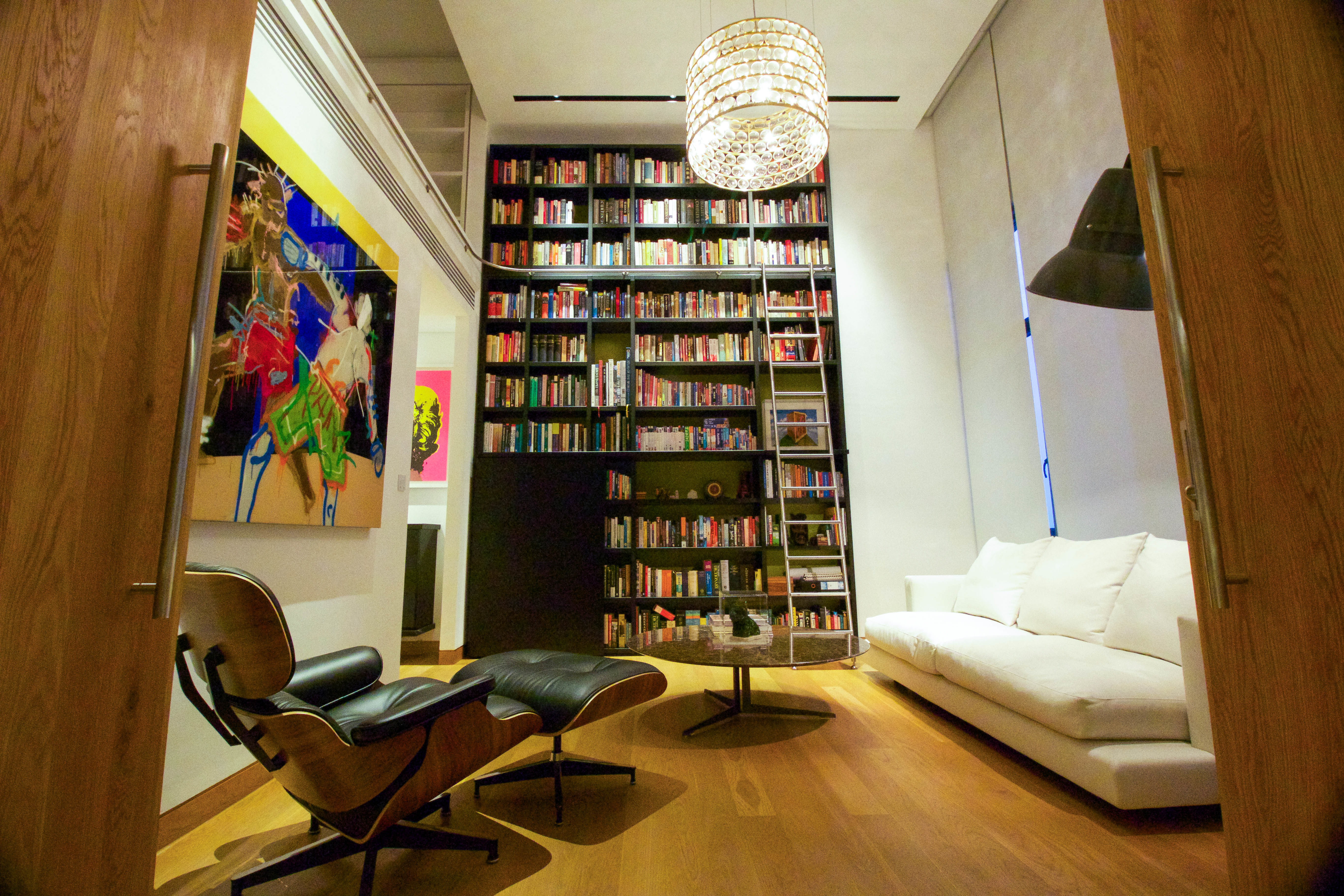 In-home library with floor to ceiling bookshelf and sliding ladder
