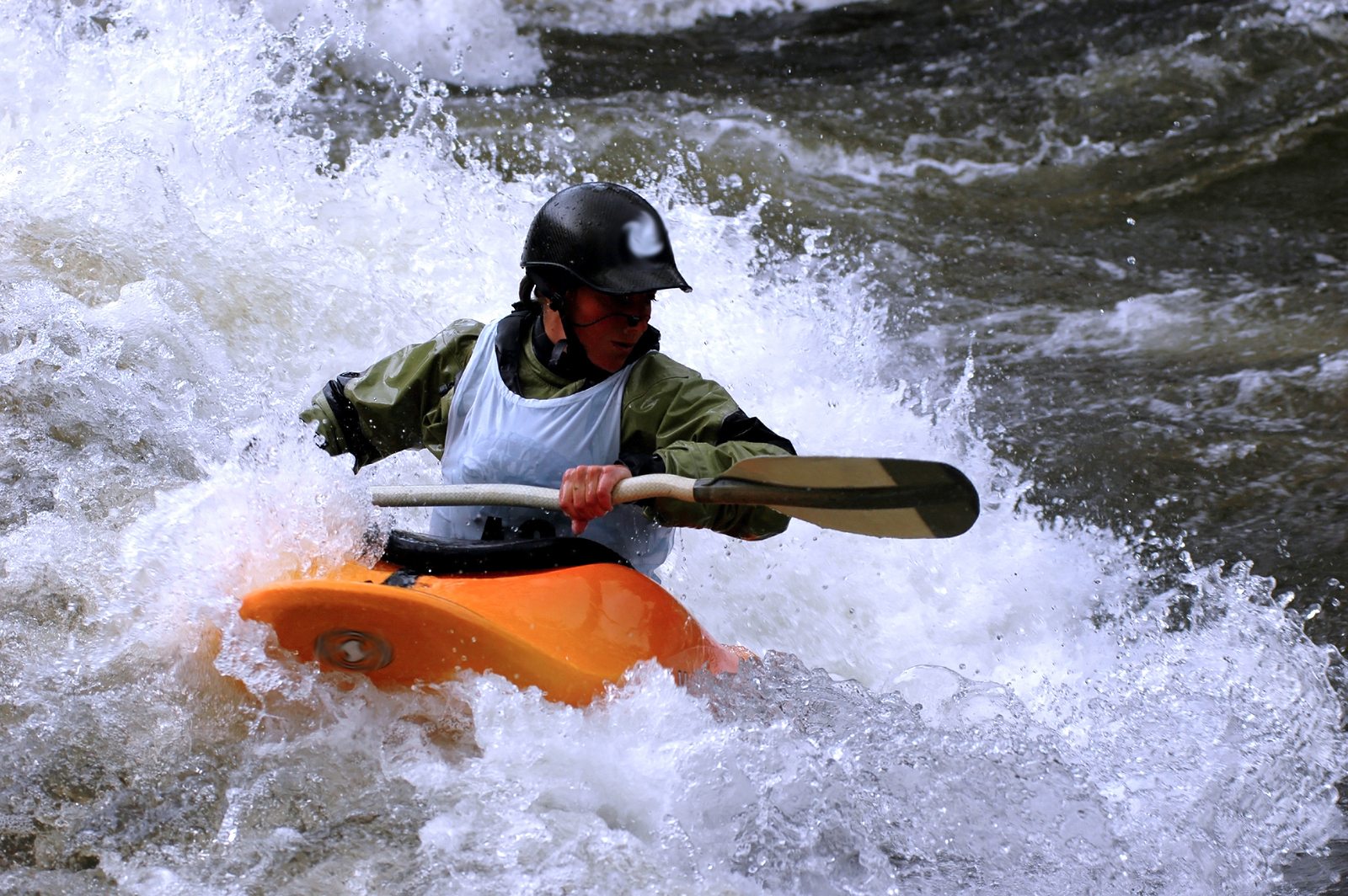 female kayak play boat competitor surfing river wave