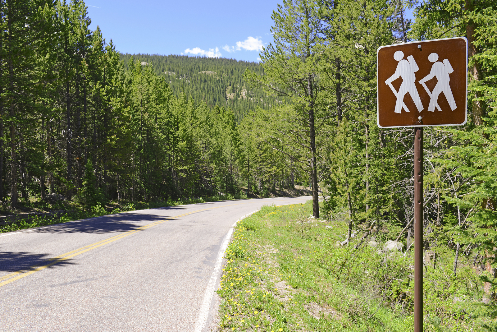 Hiker - backpacker Crossing sign in the outdoors