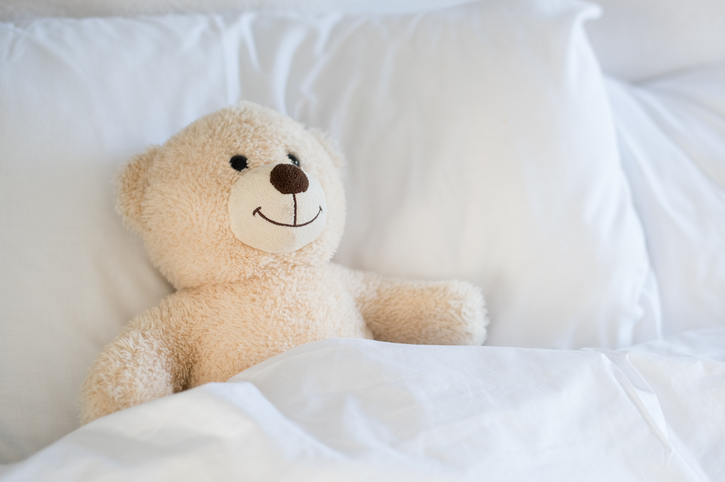 bed with teddy bear